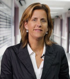 A photo of Claudine Szpilfogel, RPI Partner. Claudine has brown hair and is wearing a white shirt and black jacket.